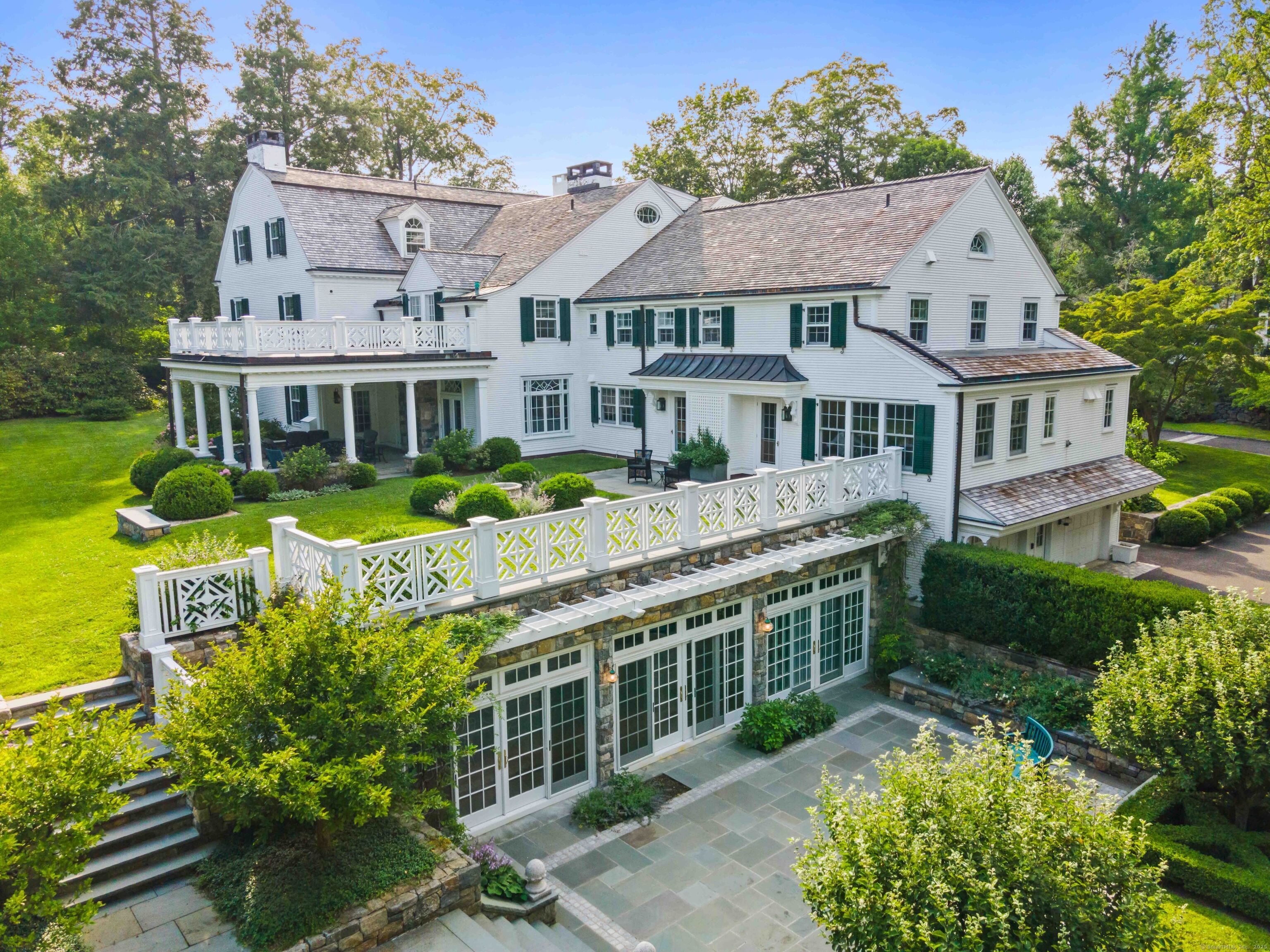 an aerial view of a house with a yard table and chairs