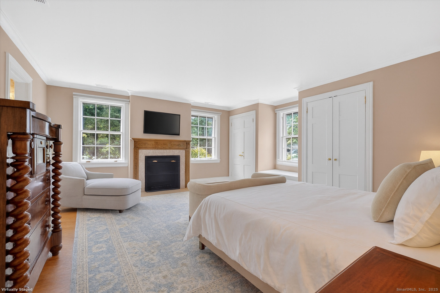 88 Main Street Ridgefield, CT 06877 - Photo 20 of 39 a bedroom with a bed a fireplace and a couch