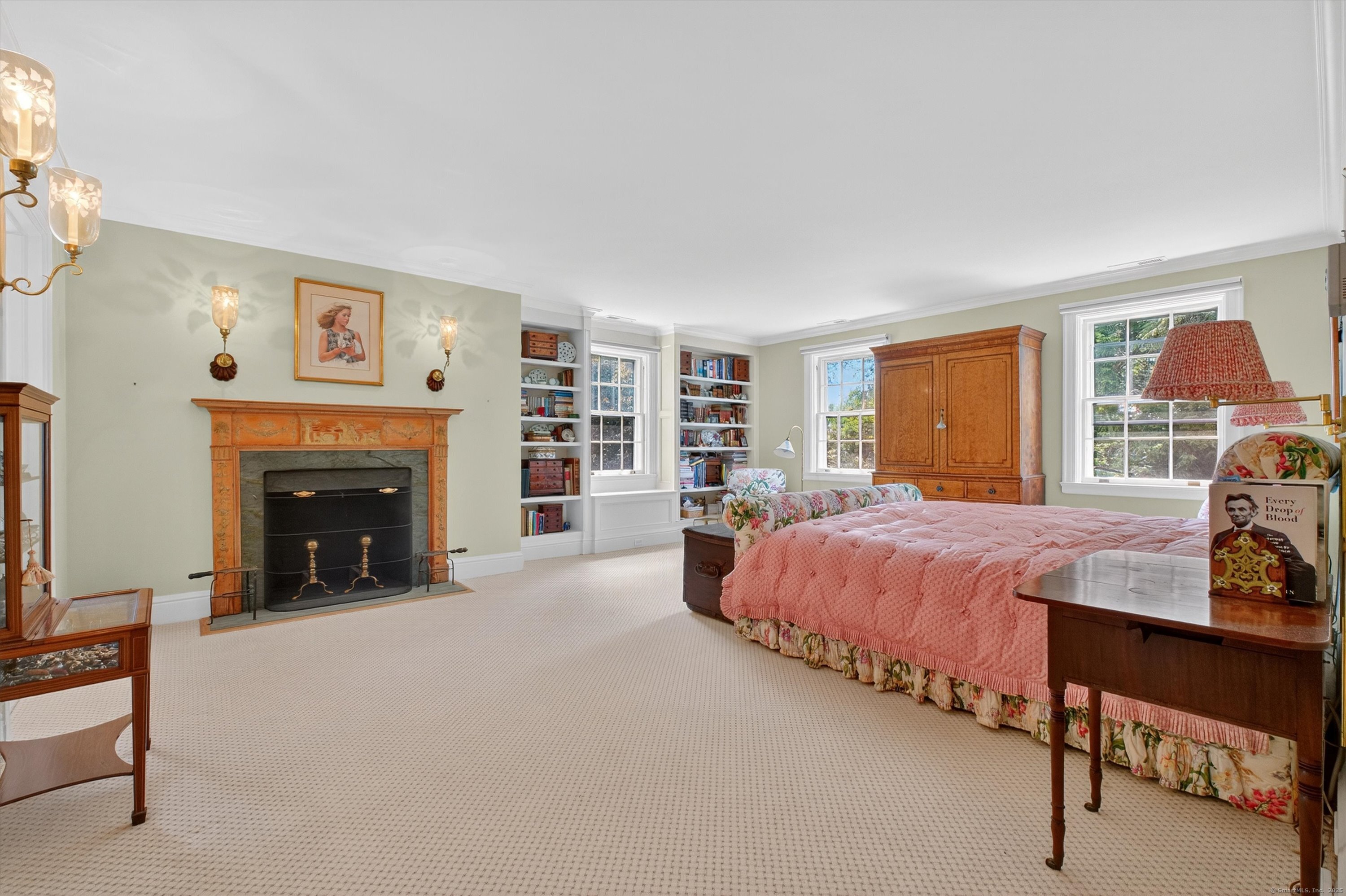 88 Main Street Ridgefield, CT 06877 - Photo 23 of 39 a spacious bedroom with a bed and a fireplace