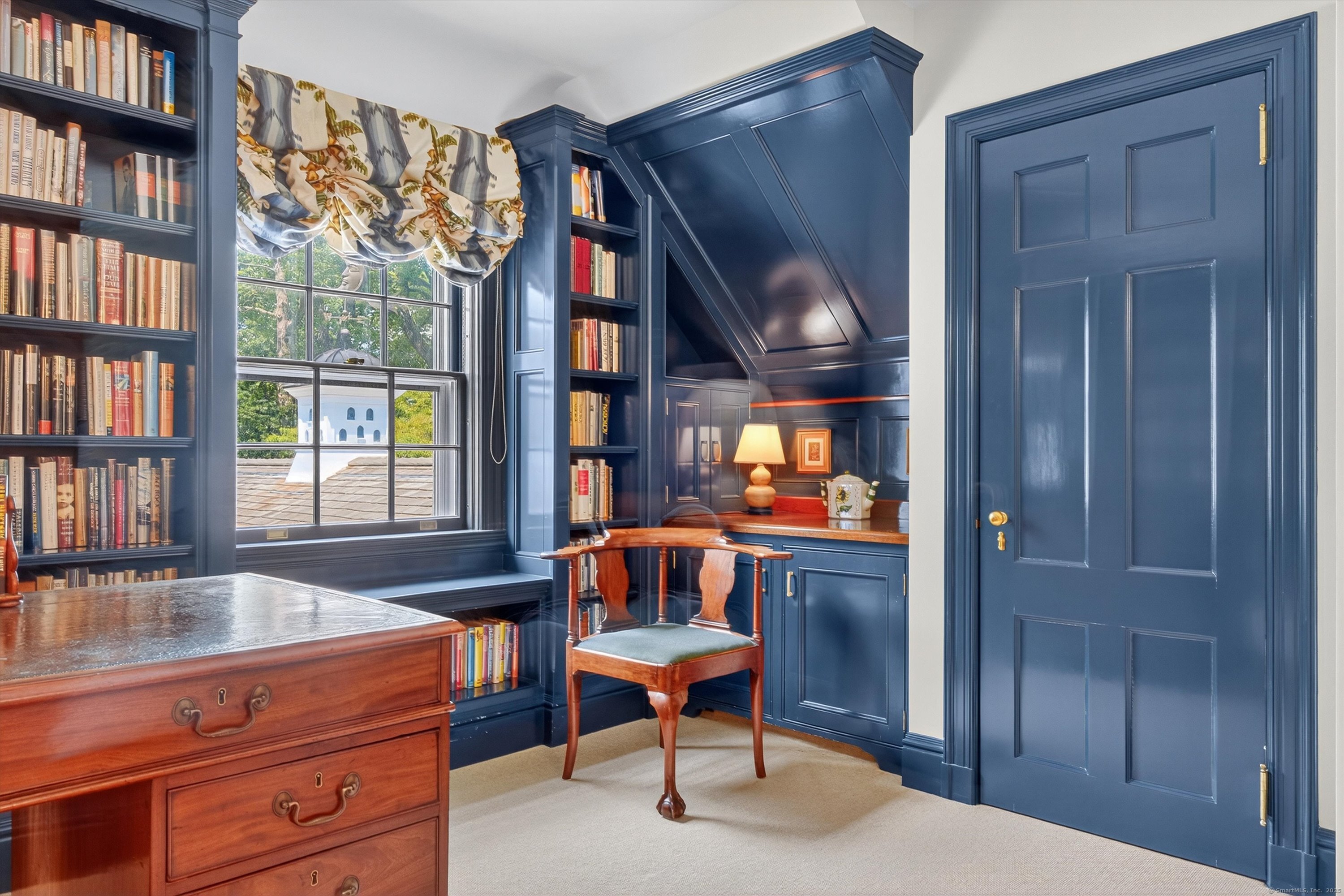 88 Main Street Ridgefield, CT 06877 - Photo 27 of 39 a living room with furniture a bookshelf and a window