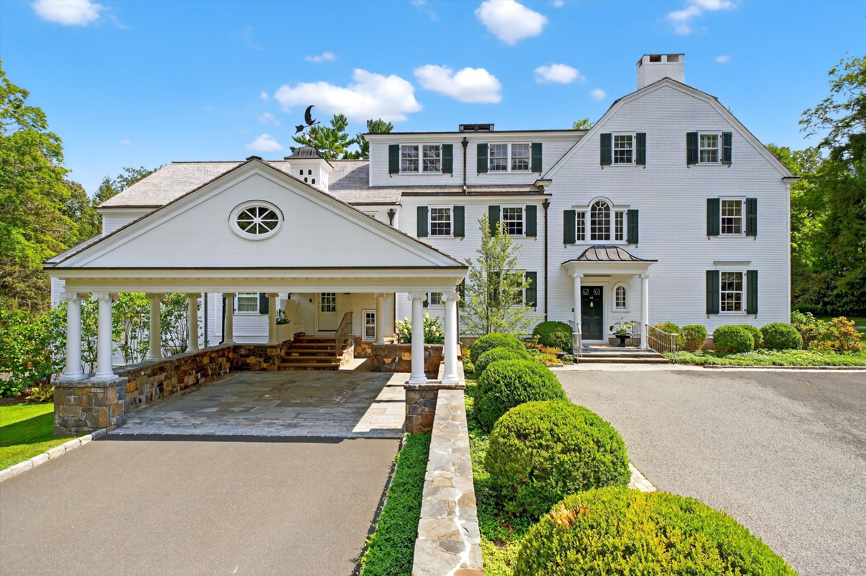 88 Main Street Ridgefield, CT 06877 - Photo 3 of 39 a front view of a house with a yard and potted plants