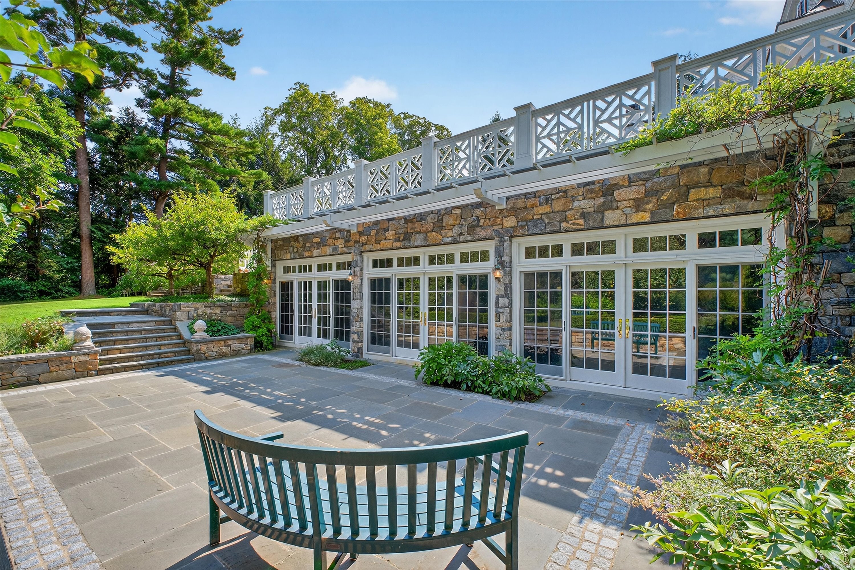 88 Main Street Ridgefield, CT 06877 - Photo 34 of 39 a view of a house with a small deck and a garden