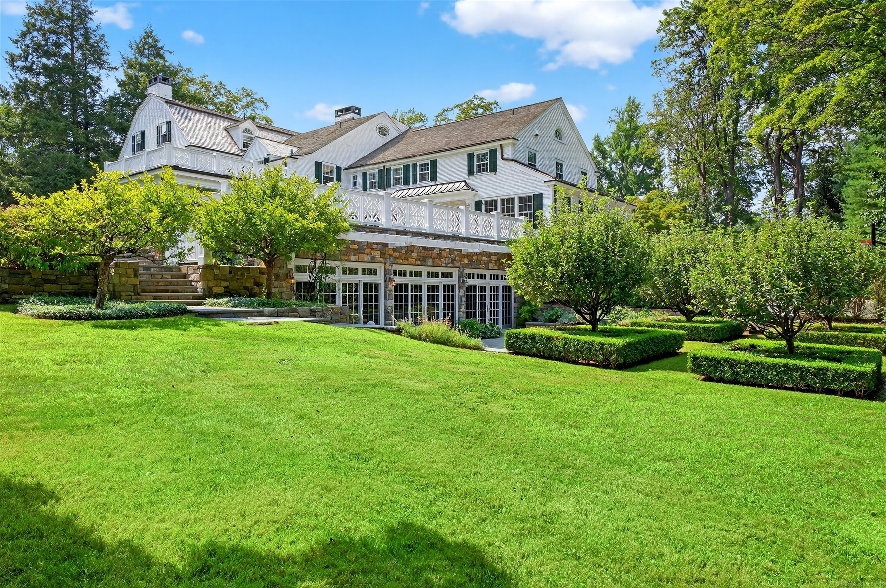 88 Main Street Ridgefield, CT 06877 - Photo 36 of 39 a front view of a house with a yard table and chairs