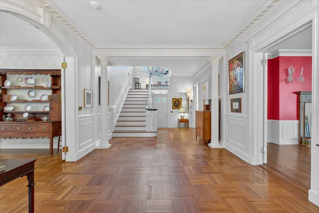 a view of entryway and hall with wooden floor