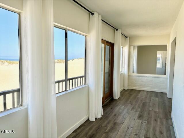3289 Ocean Drive, Unit 3 Oxnard, CA 93035 - Photo 11 of 18 an empty room with wooden floor and windows