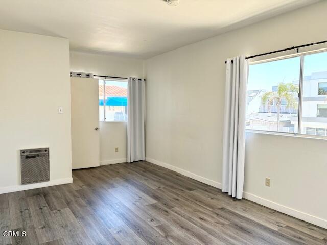 3289 Ocean Drive, Unit 3 Oxnard, CA 93035 - Photo 17 of 18 an empty room with wooden floor and windows