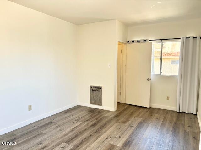 3289 Ocean Drive, Unit 3 Oxnard, CA 93035 - Photo 18 of 18 an empty room with wooden floor and a window