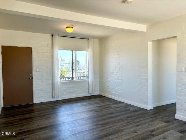 3289 Ocean Drive, Unit 3 Oxnard, CA 93035 - Photo 6 of 18 an empty room with wooden floor and windows with curtains