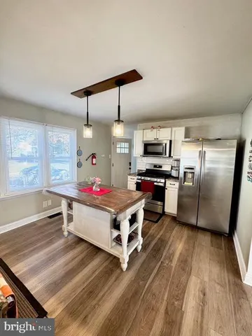 a kitchen with stainless steel appliances granite countertop a stove and a refrigerator