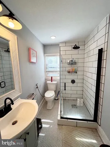 a living room with a bed furniture and a window