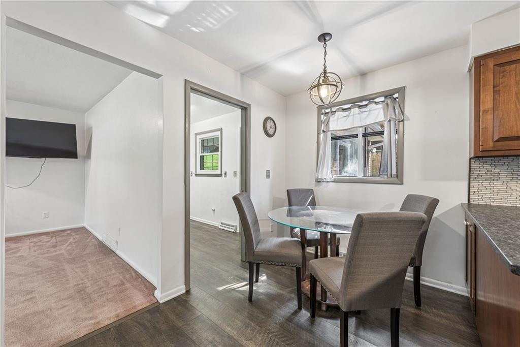 126 Jefferson Drive Apollo, PA 15613 - Photo 15 of 31 a dining room with furniture a chandelier and wooden floor