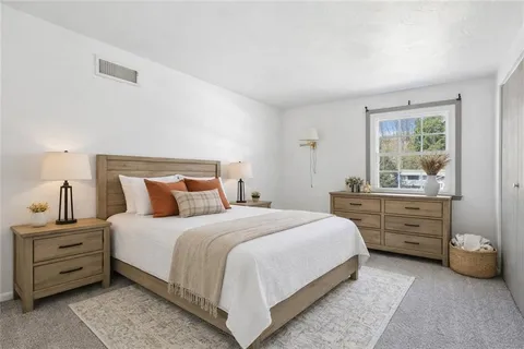 a view of a house with a yard and sitting area