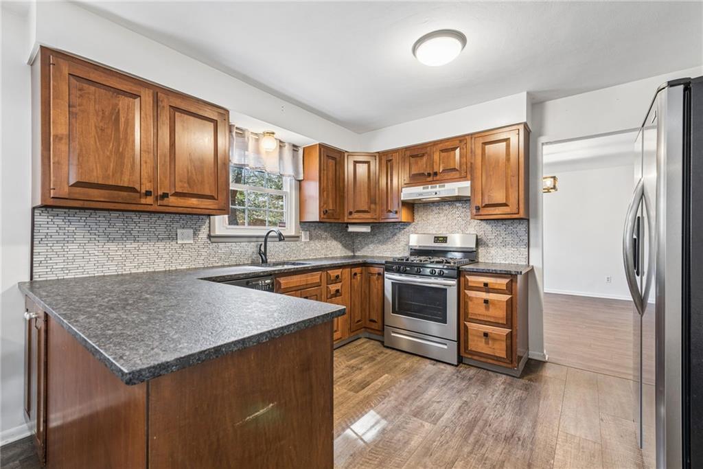 126 Jefferson Drive Apollo, PA 15613 - Photo 8 of 31 a kitchen with stainless steel appliances granite countertop a sink stove and refrigerator