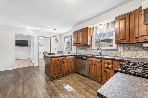 a kitchen with stainless steel appliances granite countertop a refrigerator stove and sink