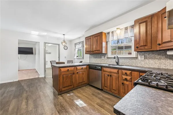 a kitchen with stainless steel appliances granite countertop a refrigerator stove and sink