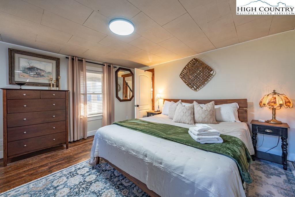 40 Painter Road Banner Elk, NC 28604 - Photo 22 of 45 a bedroom with a bed and painting on the wall