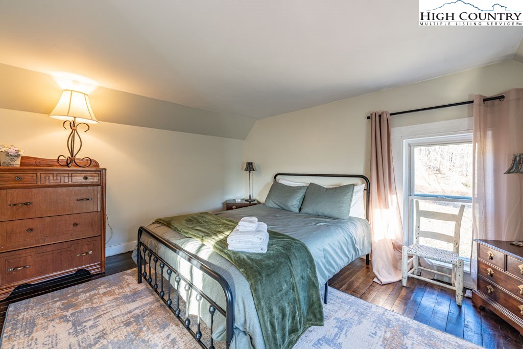 40 Painter Road Banner Elk, NC 28604 - Photo 32 of 45 a bedroom with a bed and wooden floor