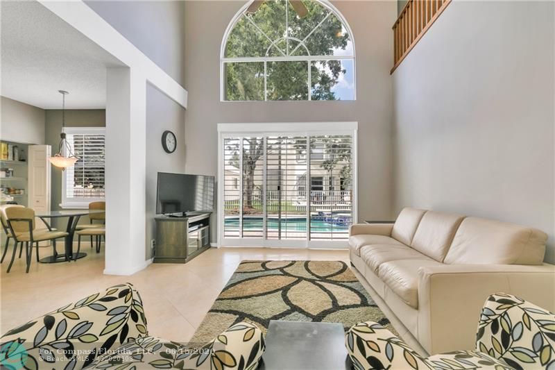 7680 Belmonte Boulevard Margate, FL 33063 - Photo 12 of 30 a living room with furniture and a flat screen tv next to a window