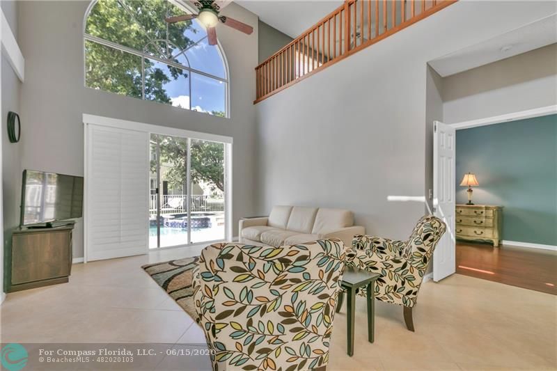 7680 Belmonte Boulevard Margate, FL 33063 - Photo 13 of 30 a bed room with a bed and a chair