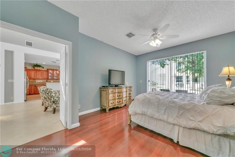 7680 Belmonte Boulevard Margate, FL 33063 - Photo 16 of 30 a bedroom with a large bed and a window