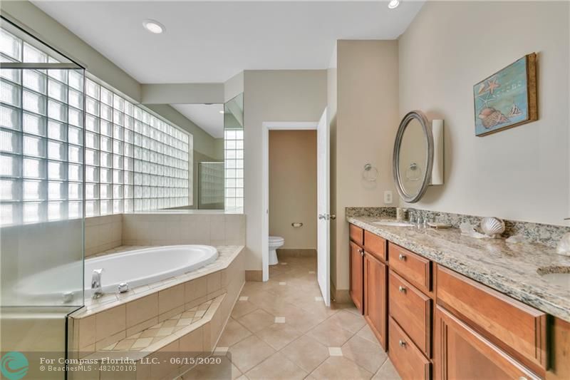 7680 Belmonte Boulevard Margate, FL 33063 - Photo 18 of 30 a spacious bathroom with a granite countertop tub sink and mirror
