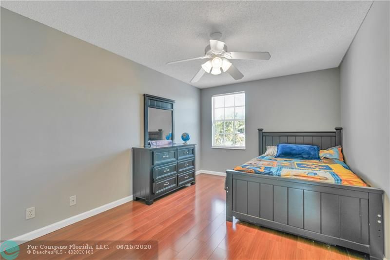 7680 Belmonte Boulevard Margate, FL 33063 - Photo 21 of 30 a bedroom with a bed and window