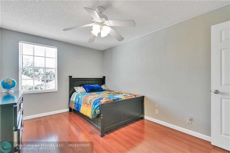 7680 Belmonte Boulevard Margate, FL 33063 - Photo 22 of 30 a bedroom with a bed and a window