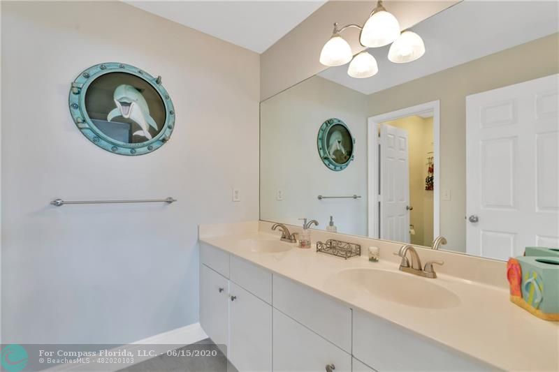 7680 Belmonte Boulevard Margate, FL 33063 - Photo 23 of 30 a bathroom with a sink and a mirror