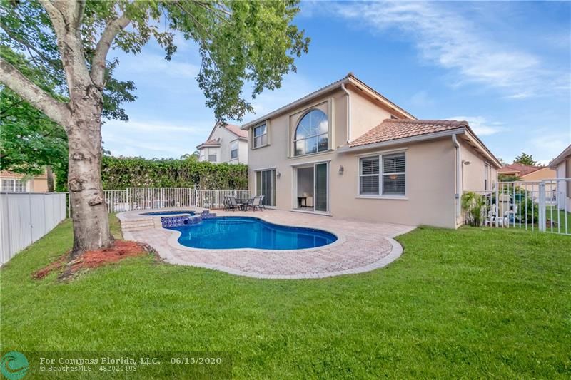 7680 Belmonte Boulevard Margate, FL 33063 - Photo 27 of 30 a backyard of a house with table and chairs
