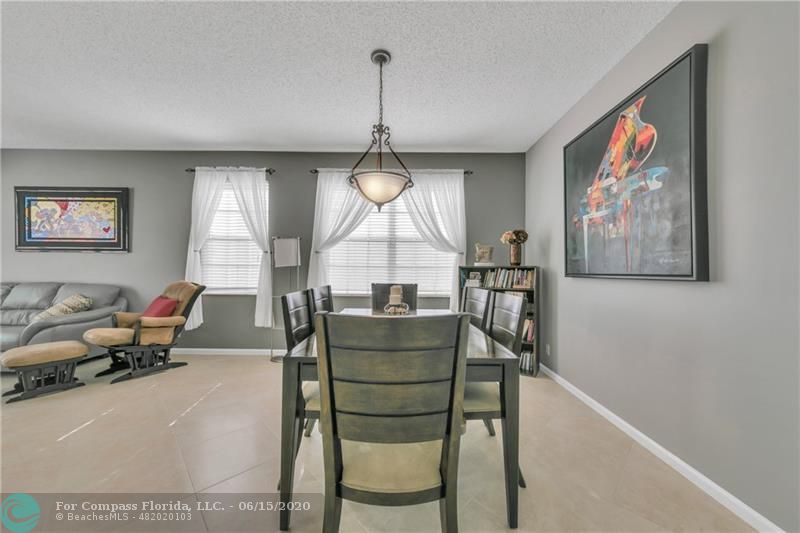 7680 Belmonte Boulevard Margate, FL 33063 - Photo 5 of 30 a living room with furniture and a chandelier