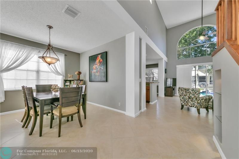 7680 Belmonte Boulevard Margate, FL 33063 - Photo 6 of 30 a view of a dining room with furniture and a chandelier