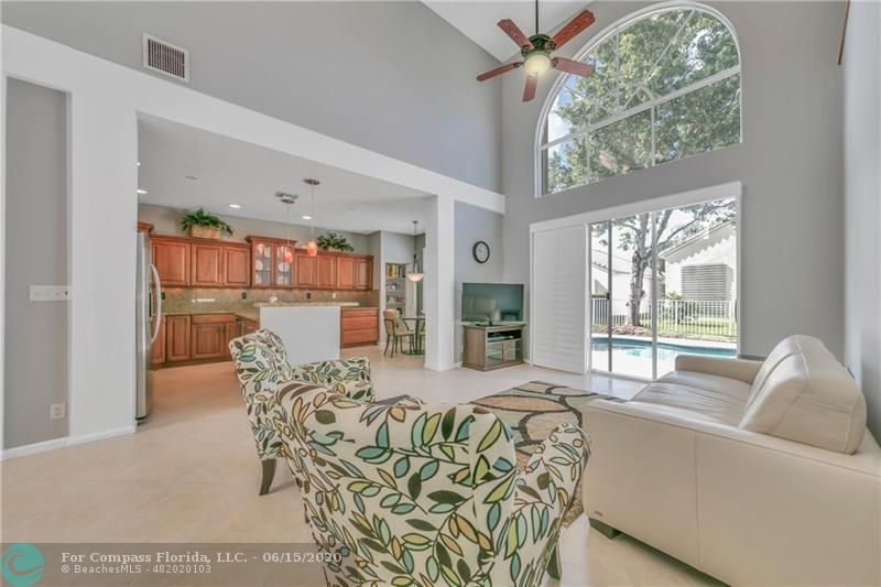 7680 Belmonte Boulevard Margate, FL 33063 - Photo 10 of 30 a living room with furniture chandelier and a large window