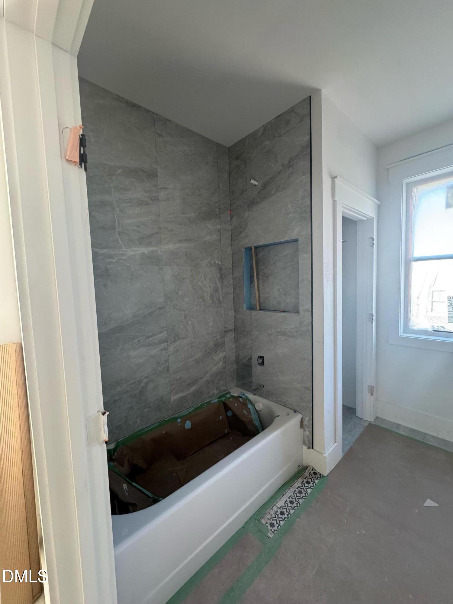 615 Velma Hopkins Lane Raleigh, NC 27603 - Photo 10 of 16 a bathroom with a tub