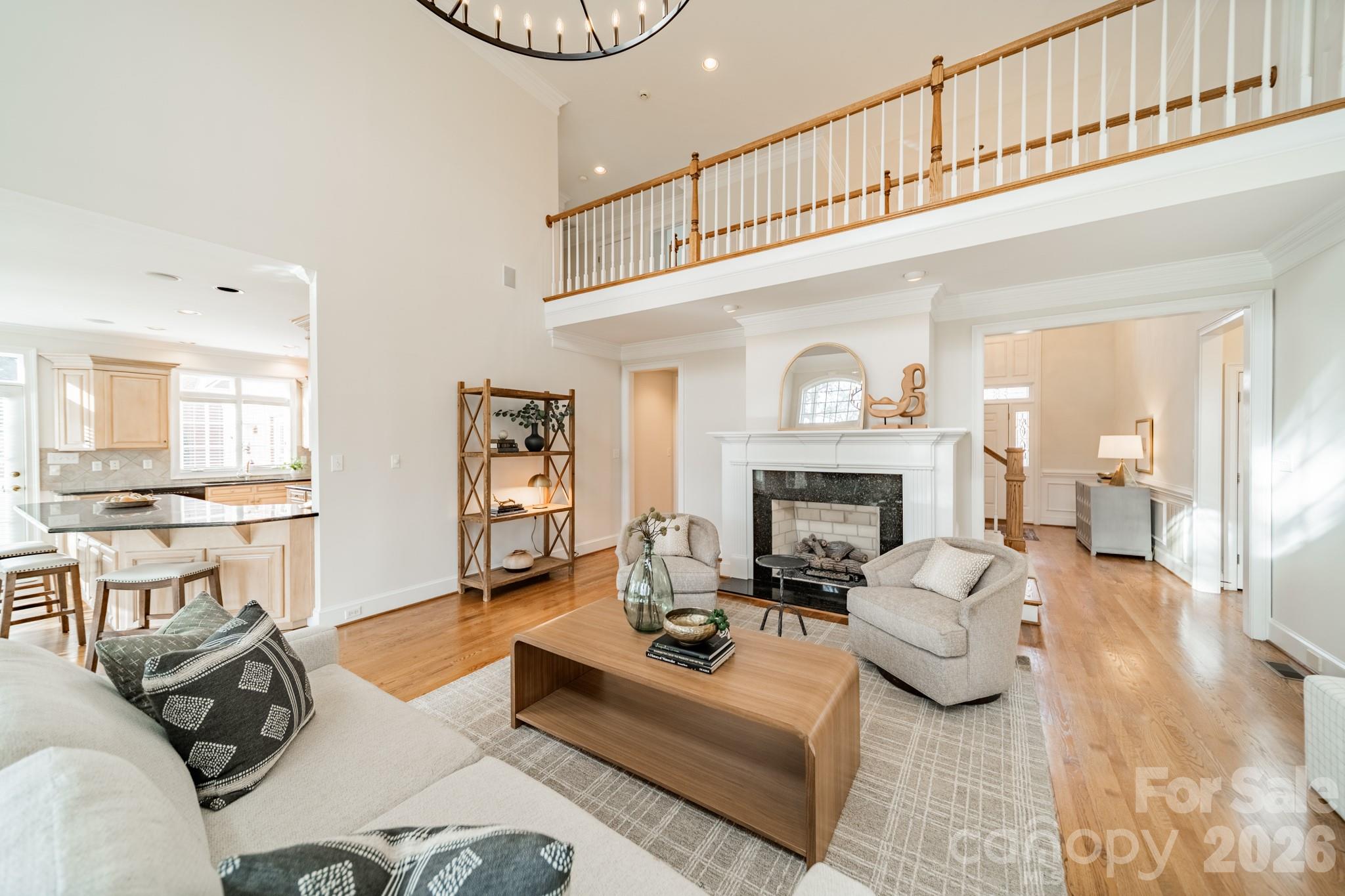 18908 Riverwind Lane Davidson, NC 28036 - Photo 11 of 35 a living room with furniture a fireplace and a chandelier