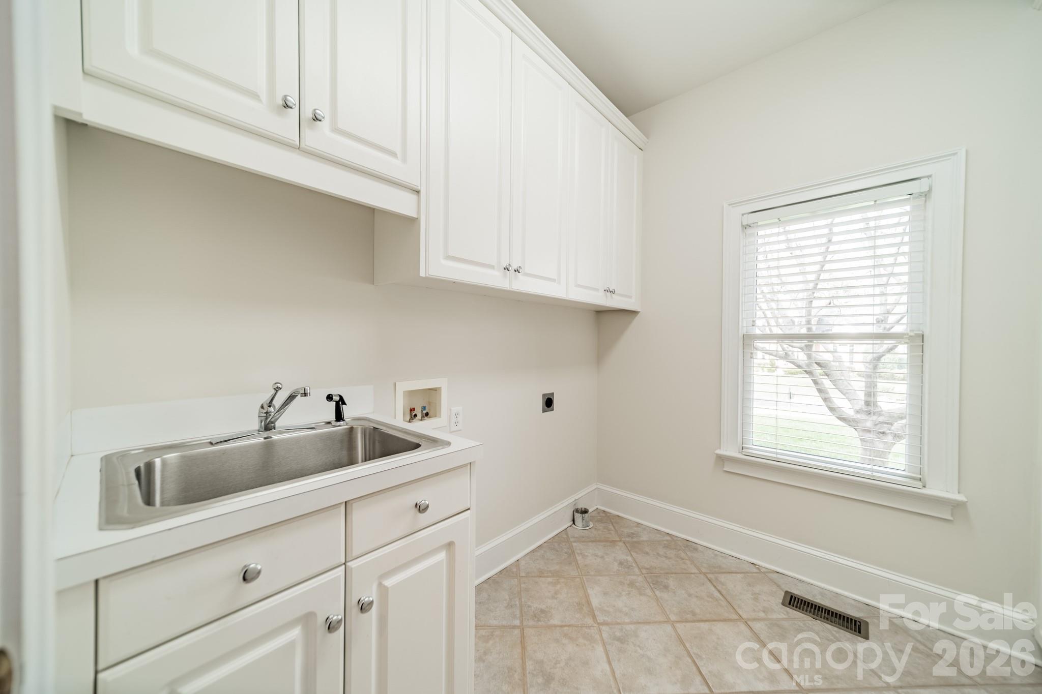 18908 Riverwind Lane Davidson, NC 28036 - Photo 16 of 35 a kitchen with white cabinets and sink