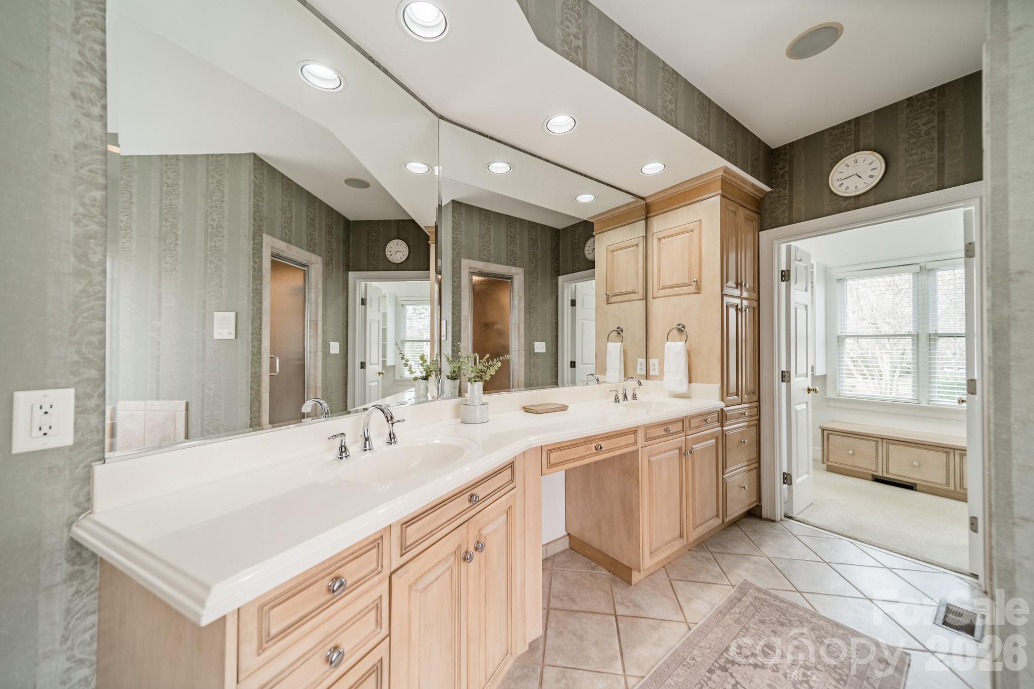 18908 Riverwind Lane Davidson, NC 28036 - Photo 20 of 35 a bathroom with a sink a large mirror and a bathtub