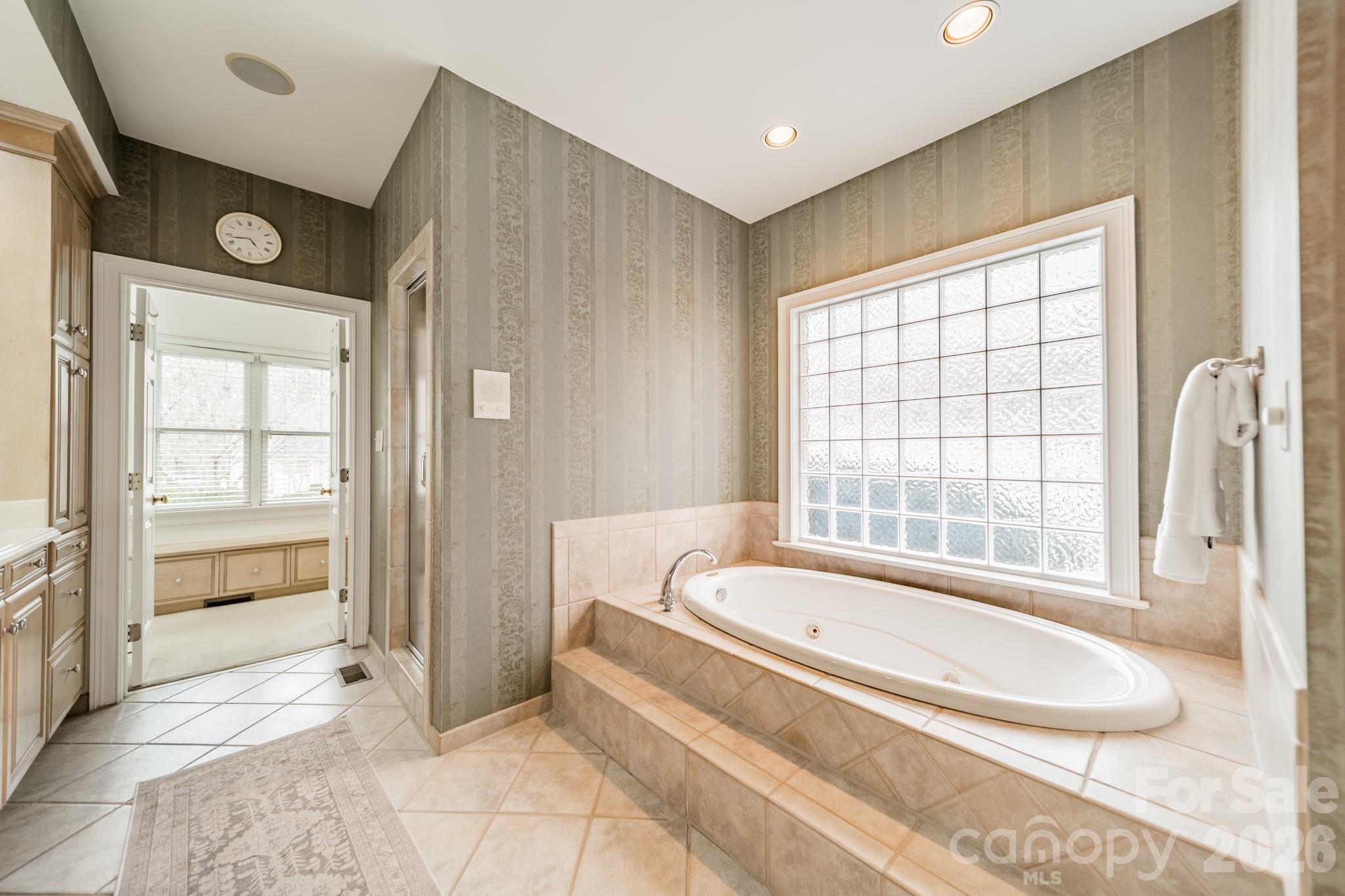 18908 Riverwind Lane Davidson, NC 28036 - Photo 21 of 35 a bathroom with a tub and shower