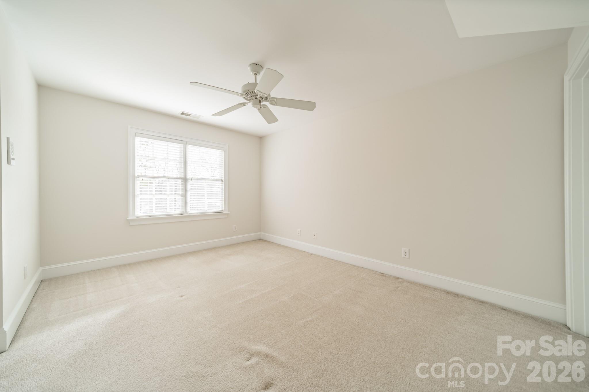 18908 Riverwind Lane Davidson, NC 28036 - Photo 27 of 35 an empty room with windows and ceiling fan