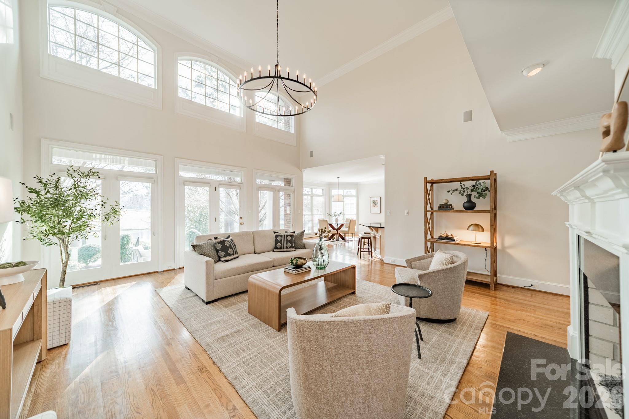 18908 Riverwind Lane Davidson, NC 28036 - Photo 10 of 35 a living room with fireplace furniture and a chandelier