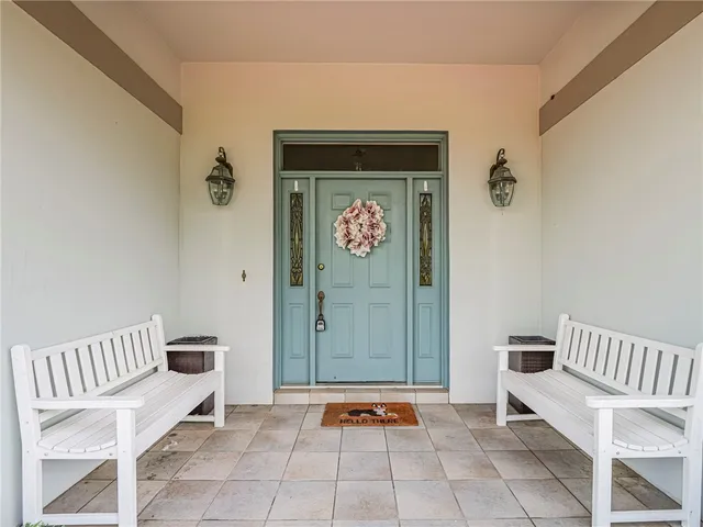 a view of front door with a bench