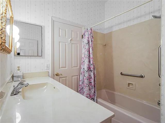 a bathroom with a bathtub and a sink