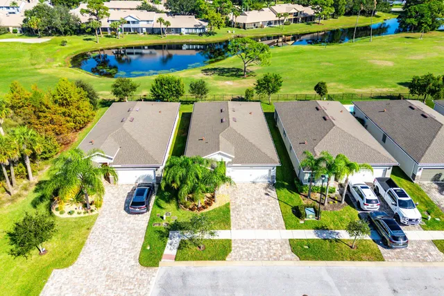 an aerial view of a house with a garden and lake view