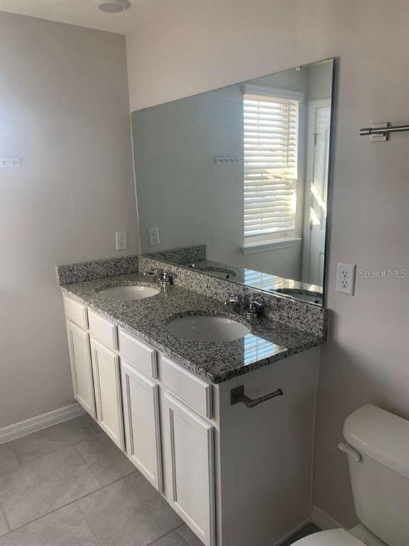 13251 Pontoon Road Winter Garden, FL 34787 - Photo 14 of 24 a bathroom with a granite countertop sink and a toilet