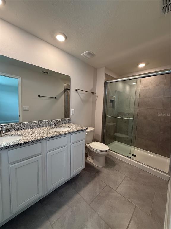 13251 Pontoon Road Winter Garden, FL 34787 - Photo 15 of 24 a bathroom with a double vanity sink toilet and shower