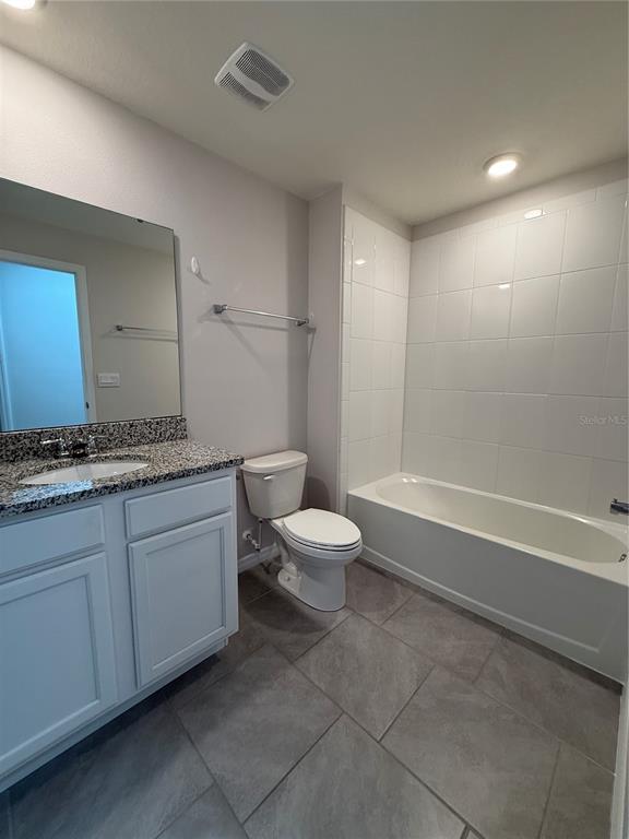 13251 Pontoon Road Winter Garden, FL 34787 - Photo 17 of 24 a bathroom with a granite countertop toilet a sink and a mirror