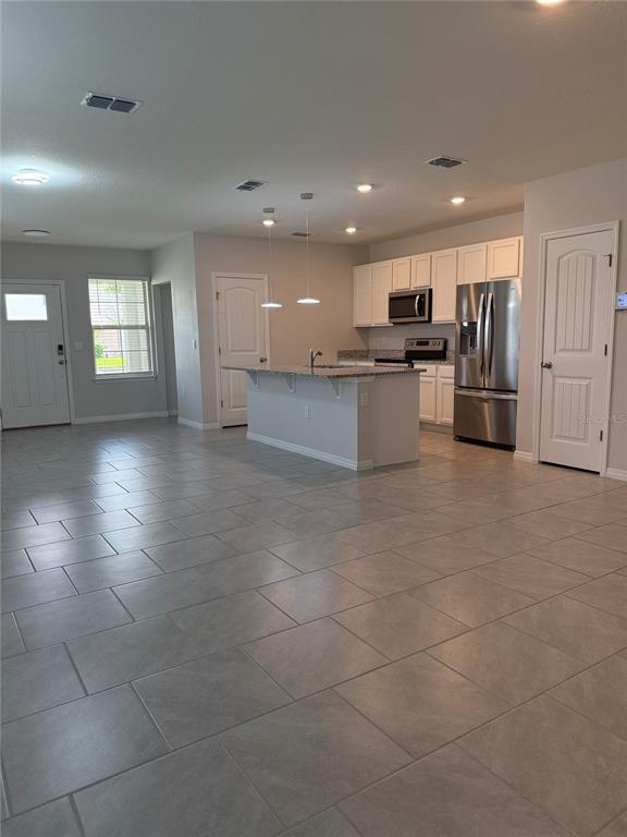 13251 Pontoon Road Winter Garden, FL 34787 - Photo 7 of 24 a kitchen with stainless steel appliances kitchen island granite countertop a sink and cabinets