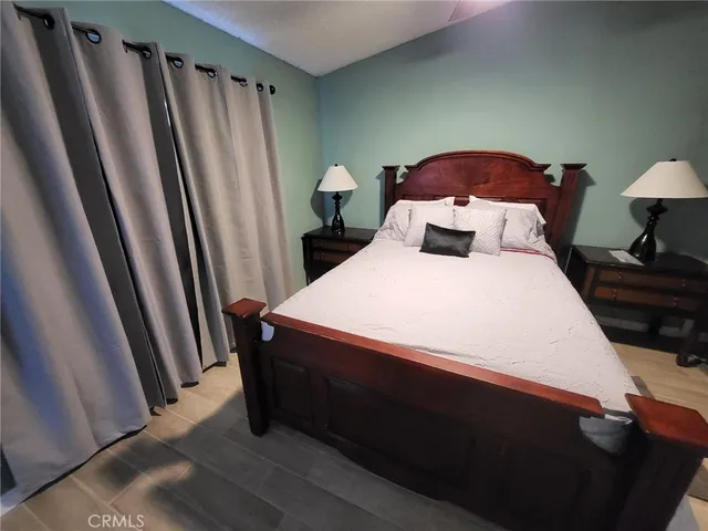 a bed sitting in a bedroom next to a window