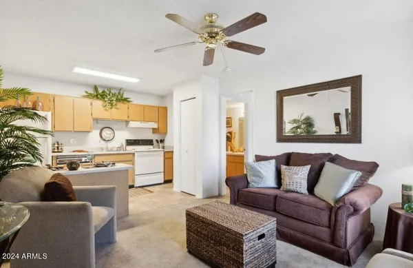a living room with furniture and a kitchen