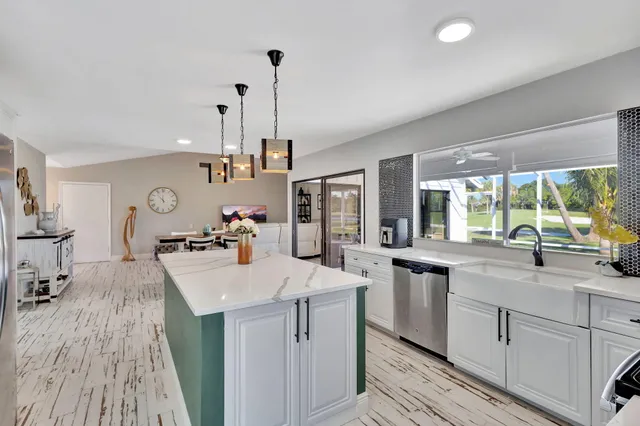 a kitchen with sink refrigerator and stove