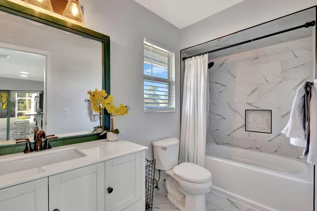 a bedroom with furniture a bed and a large window